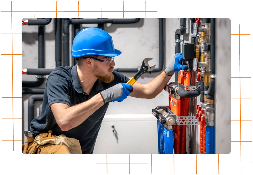 Commercial plumber working on industrial pipes